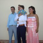 Λίγο πριν την βάφτιση, στην αγκαλιά του Νονού, με το μπαμπά και τη μαμά.